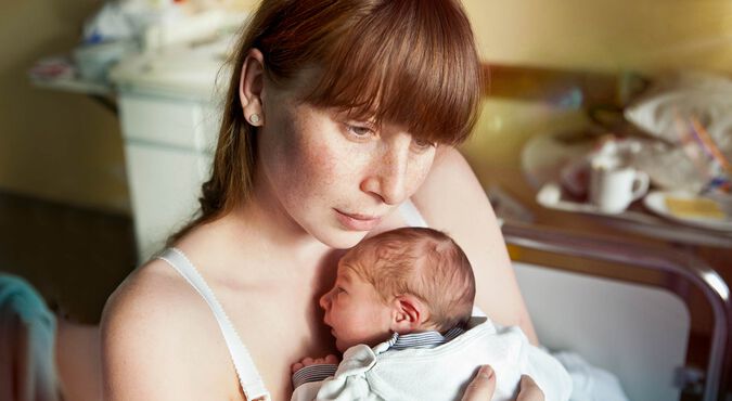 Mulher segurando bebê recém nascido