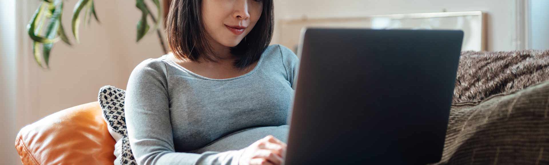 Mulher grávida mexendo no computador